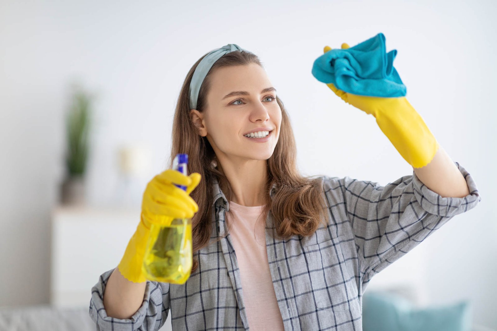 woman cleaning commercial space windows
